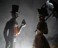 Skeleton figurines clothed in Victoria outfits.