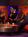 On a TV chat show, guests look to one of their own talking to the audience. 