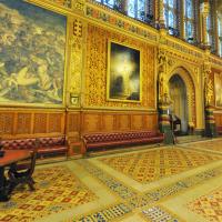 A grand highly dercorated hall in the neo-gothic style, with encaustic tiles in the foreground.