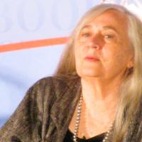 An author sits and listens.