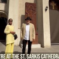 A couple stand on the steps of a cathedral in Iran.