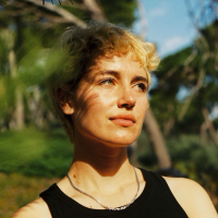 A woman stares away from the camera