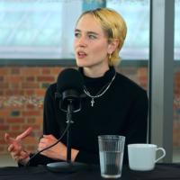A podcast guest gestures with her hand while talking