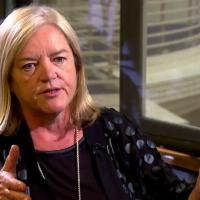 A woman talks in an interivew.