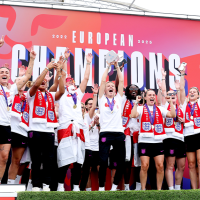 A victorious women's football team celeberate.