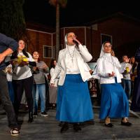Two nuns with a band rap on stage