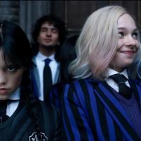 Wednesday Adams scowls while Enid smiles.