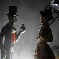 Skeleton figurines clothed in Victoria outfits.