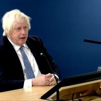Boris Johnson sits, giving evidence to an inquiry.